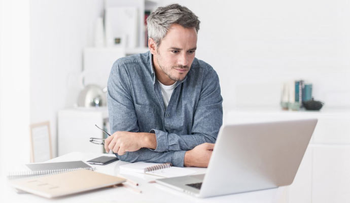 Man looking at home security cameras