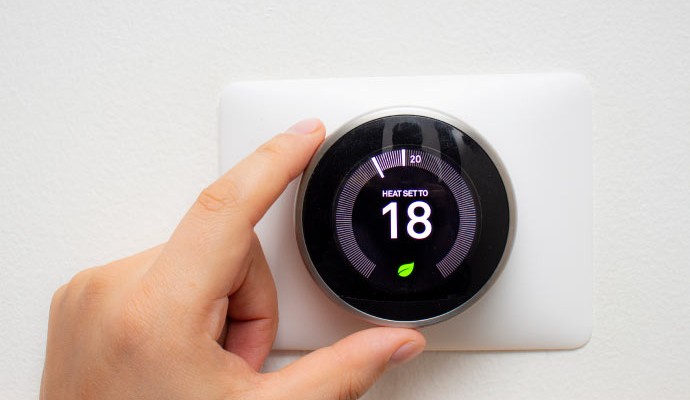 Person controlling smart thermostat