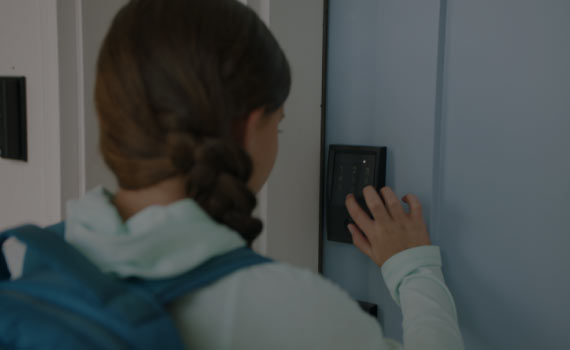 a woman entering pin in schlage encode smart wifi deadbolt