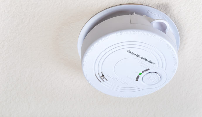 An installed carbon monoxide detector on the ceiling
