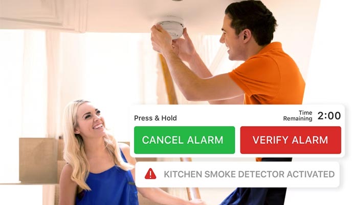A Professional installing a carbon monoxide detector on ceiling