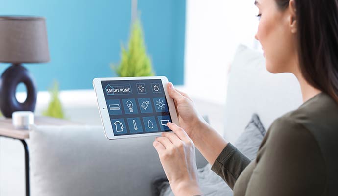A person interacting with an interactive home security system on a tablet
