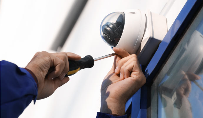 Technician installing outdoor dome camera